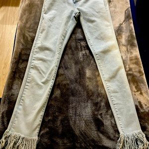 Light denim stretch jeans with distressed bottoms